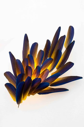 Illuminated feather wall sconce with deep blue & gold hues & ethereal textures by Janaïna Milheiro available through RUNE, New York.