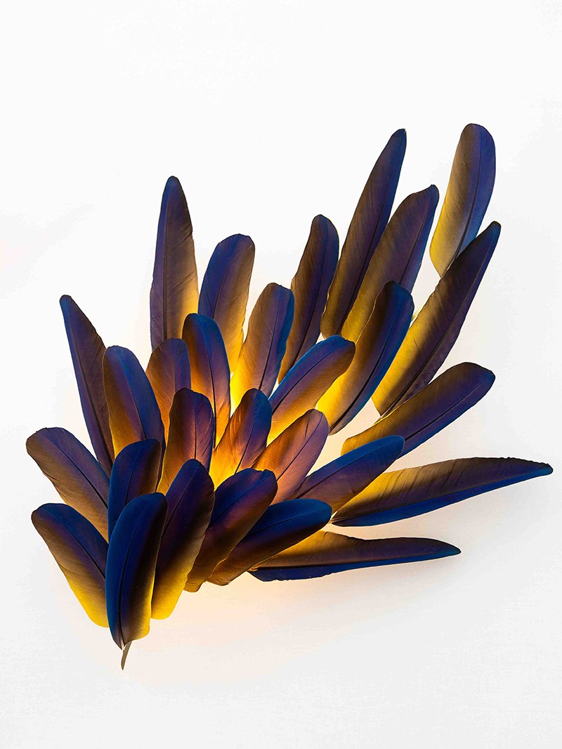 Illuminated feather wall sconce with deep blue & gold hues & ethereal textures by Janaïna Milheiro available through RUNE, New York.