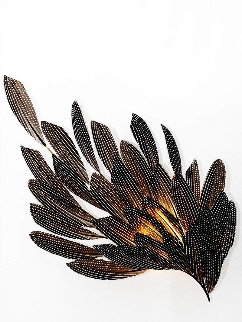Illuminated feather wall sconce illustrates the bespoke lighting design capabilities of Janaïna Milheiro available through RUNE, New York.