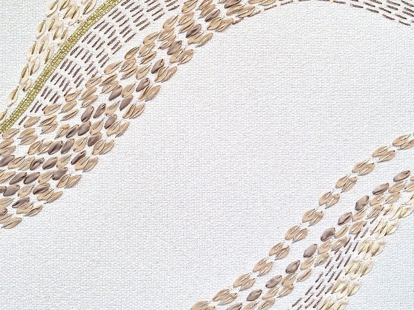 Detailed view of P+L Studio’s French embroidered fabric, highlighting colorful threadwork & texture in a modern, wave-like pattern.